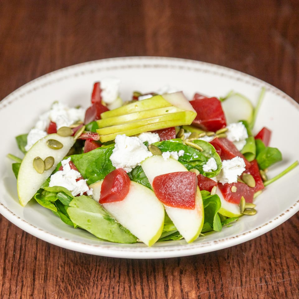 Himalayan Cuisine's fresh salad with spinach, sliced pears, beets, feta cheese, and pumpkin seeds.