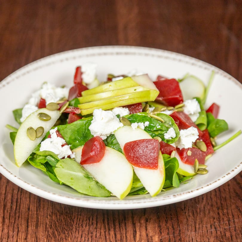 Himalayan Cuisine's fresh salad with spinach, sliced pears, beets, feta cheese, and pumpkin seeds.